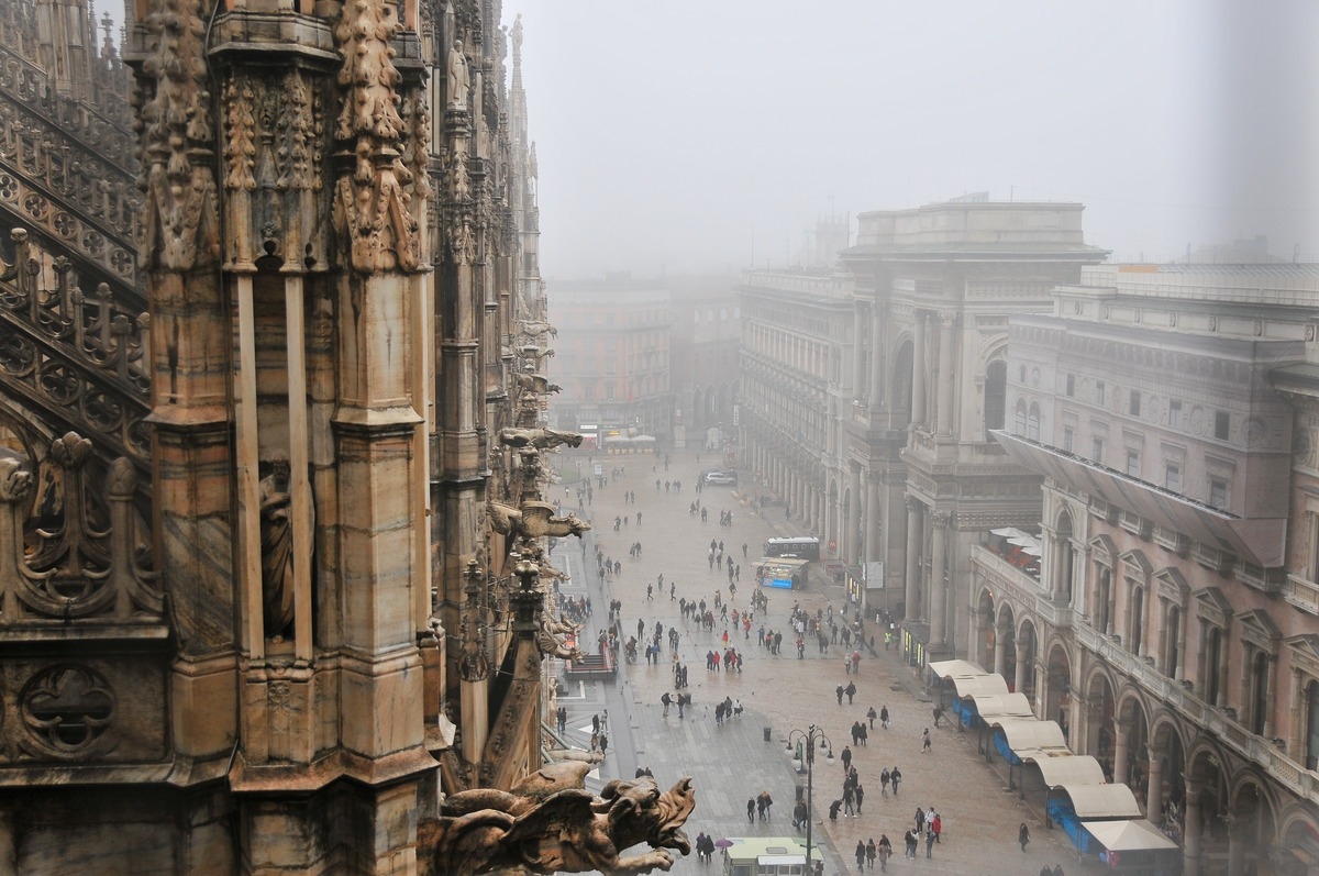 a rainy and foggy morning at the duomo in milan