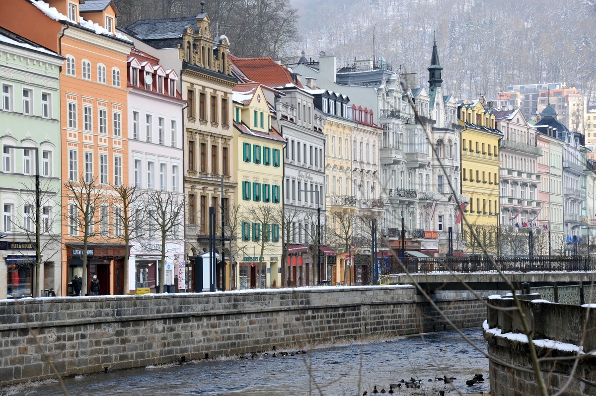 row of colorful houses along the river in Karlovy Vary, Czech Republic