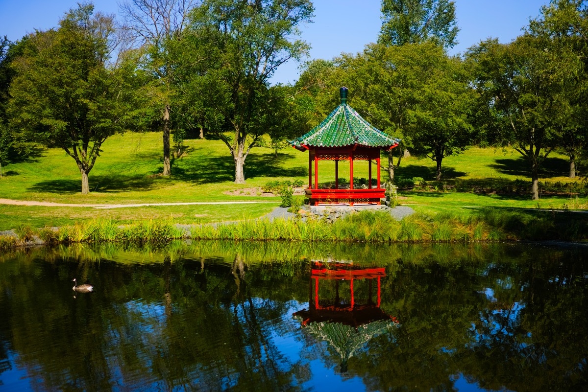 red hut by the lake with reflection