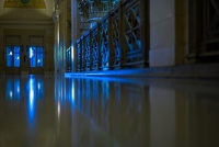 view down the corridor with blue lights: a floor view of the corridor with blue cold light from the windows