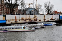 tour boats at the pier: amsterdam pier and canal with tour boats