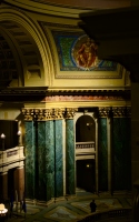warm light and romanesque architecture : interior shot of the madison capitol building with pillars and murals