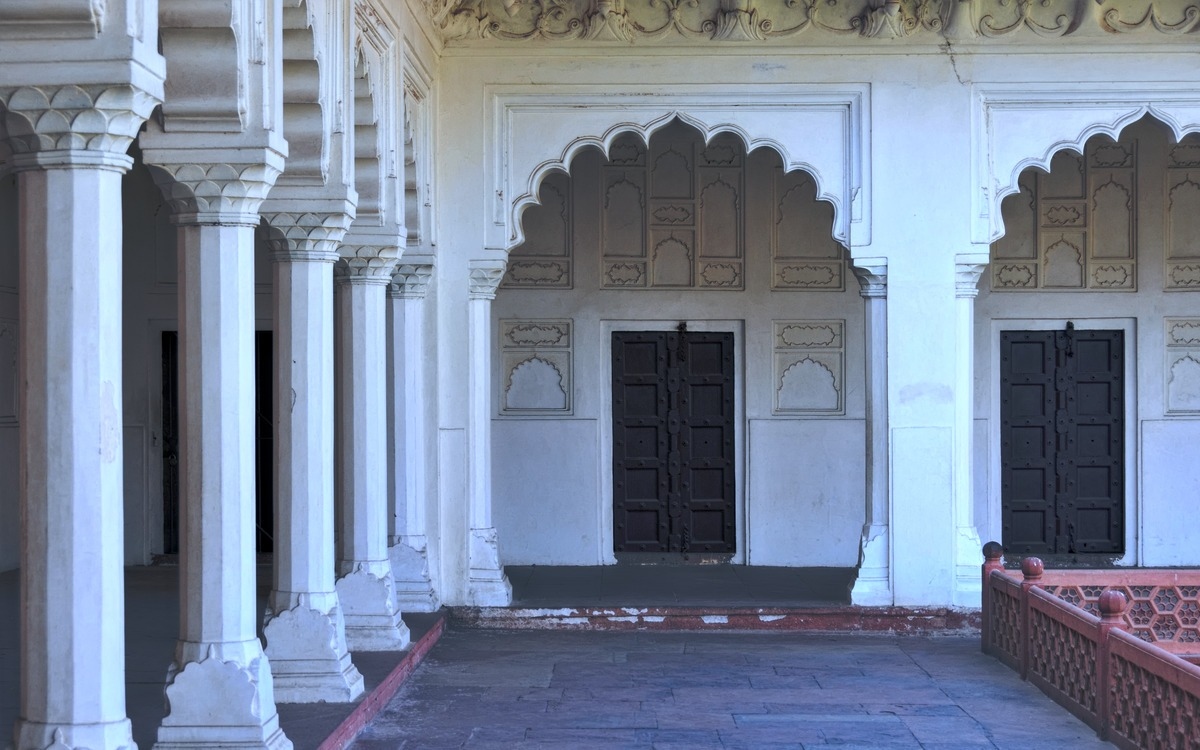 black doors with white walls and pillars