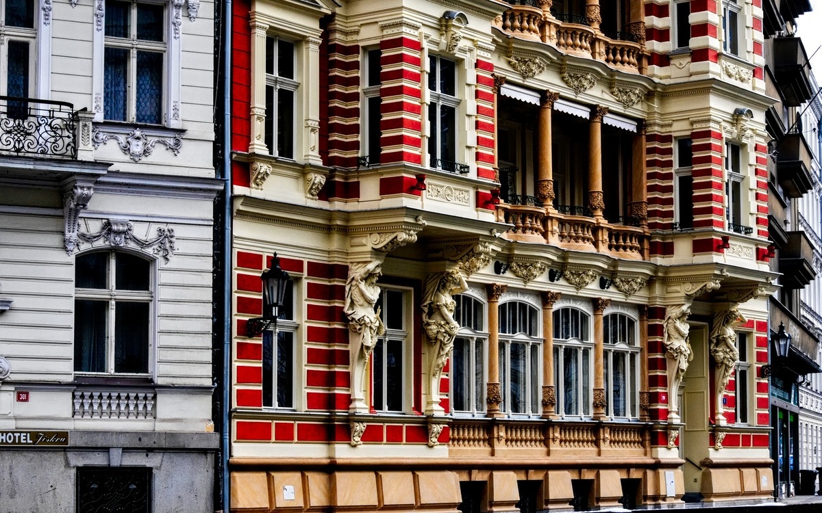 the bright red facade of a hotel in karlovy vary in czechia