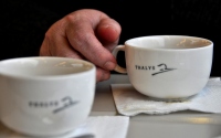 two cups of coffee and a hand : a hand with a cup of coffee on the thalys