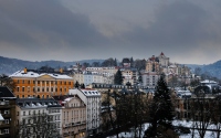 colorful buildings set against a mountain with blue skies in karlovy vary in czech republic