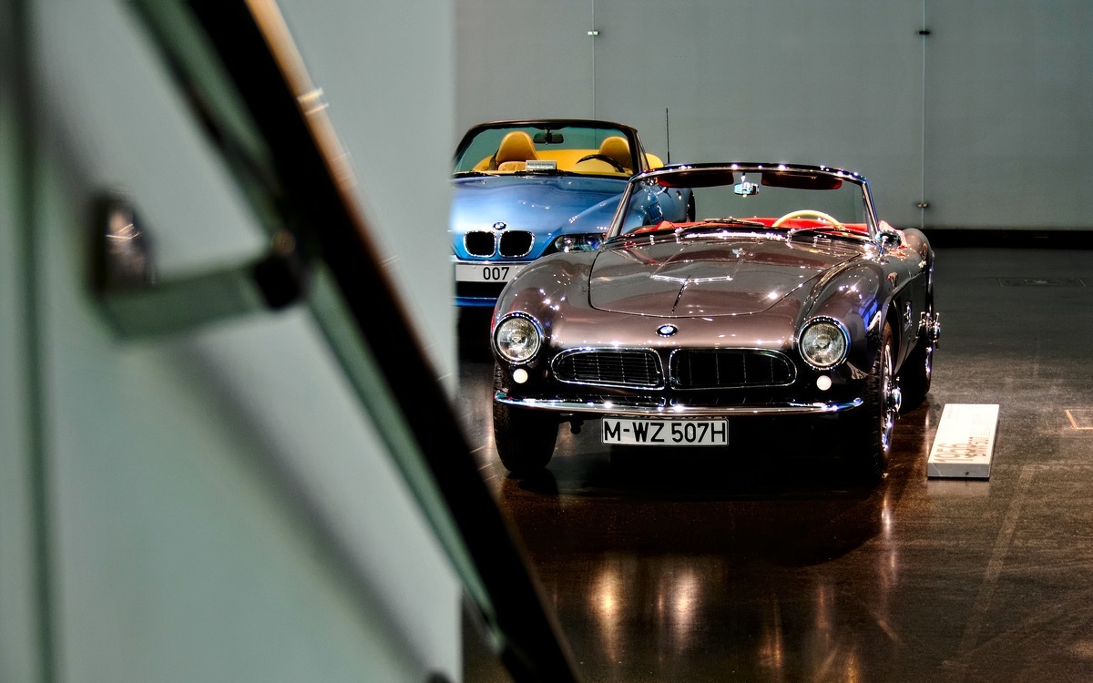 a blue new bmw alongside a vintage 1956 model at the bmw welt in munich