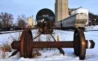 abandoned rail wheels in the snow : rail yard in the snow with abandoned wheel