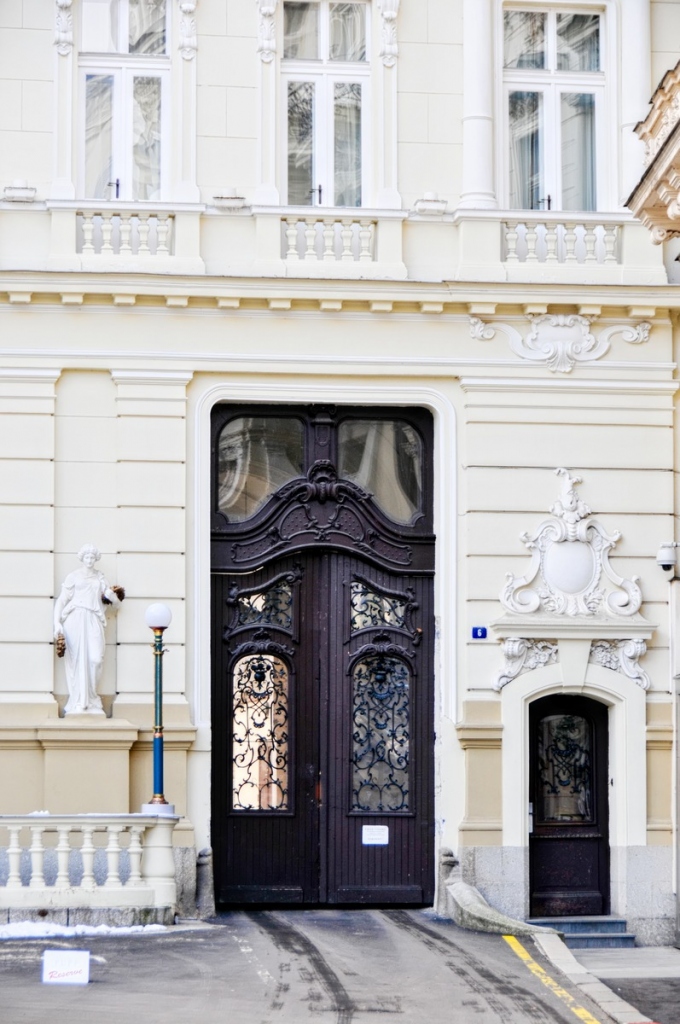 black door to the building with a small side door in karlovy vary in czechia