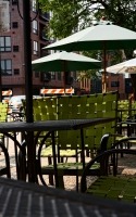 by the street, green chairs and green trees